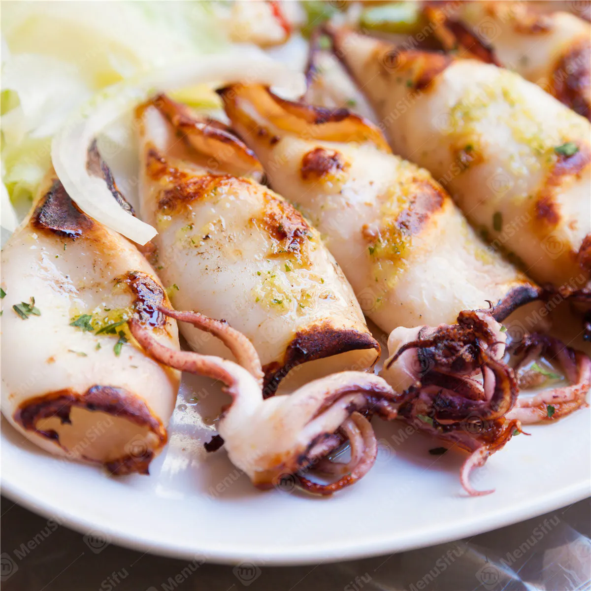 Grilled squid with garlic herb seasoning served with lemon wedges at Rock Seafood and Fried Crabhouse, a Seafood Restaurant in Baltimore