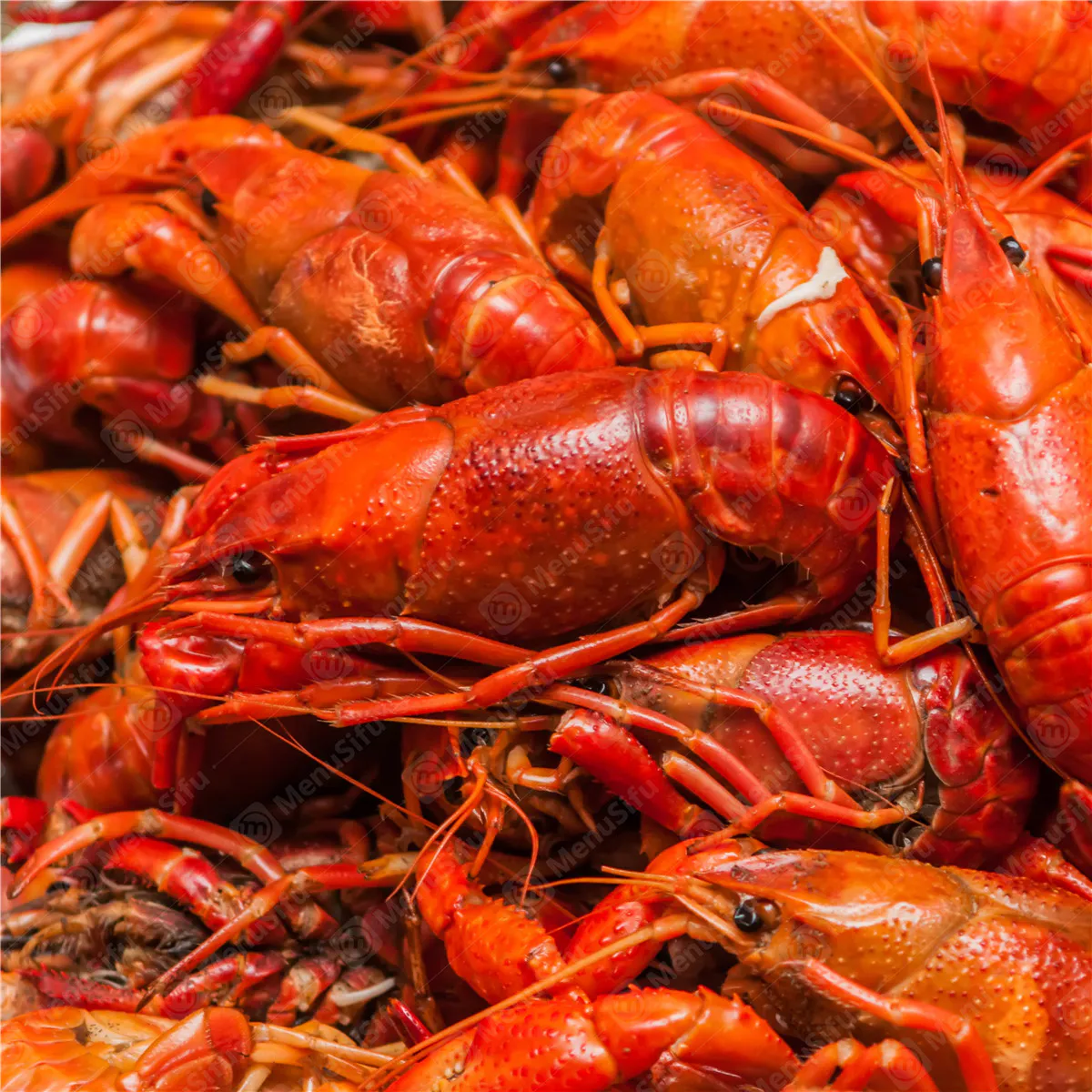 Close-up of bright red boiled crawfish with Cajun spices at Rock Seafood and Fried Crabhouse, a Seafood Restaurant in Baltimore